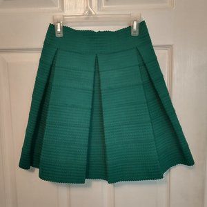 Pleated, emerald green mini skirt